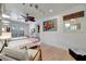 Inviting bedroom featuring white shiplap walls, light wood floors, and bright, colorful artwork at 880 N Shore Dr, Anna Maria, FL 34216