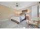 Inviting bedroom with woven bed, neutral tones, fan, and bright light at 880 N Shore Dr, Anna Maria, FL 34216