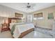 Cozy bedroom featuring a wicker bed frame, ceiling fan, and soft natural lighting at 880 N Shore Dr, Anna Maria, FL 34216