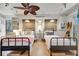 Bright bedroom with white shiplap walls and hardwood floors, has two twin beds and twin windows at 880 N Shore Dr, Anna Maria, FL 34216
