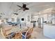 Cozy dining area with modern table and chairs, next to an open, updated kitchen, and stylish decor at 880 N Shore Dr, Anna Maria, FL 34216