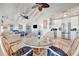 Bright dining area features a round dining table and an open floor plan leading to the kitchen and living room at 880 N Shore Dr, Anna Maria, FL 34216