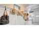 Stylish hallway featuring hats and bags hanging on the wall, leading to various rooms at 880 N Shore Dr, Anna Maria, FL 34216
