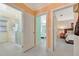 Hallway with doorways leading to the bathroom and bedroom with views of natural light at 880 N Shore Dr, Anna Maria, FL 34216