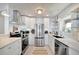 Updated kitchen with stainless steel appliances, white cabinetry, and a sleek design at 880 N Shore Dr, Anna Maria, FL 34216