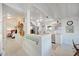 Open kitchen with white cabinetry, stainless steel appliances, and breakfast bar seating at 880 N Shore Dr, Anna Maria, FL 34216