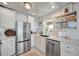 Modern kitchen featuring stainless appliances, white cabinets, and subway tile backsplash at 880 N Shore Dr, Anna Maria, FL 34216
