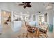 Bright, open concept shows the kitchen, island seating, and dining area at 880 N Shore Dr, Anna Maria, FL 34216