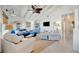 Bright living room boasts a vaulted white ceiling, comfortable seating, and stylish decorations with natural light at 880 N Shore Dr, Anna Maria, FL 34216