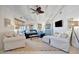 Bright living room with white shiplap ceilings, cozy seating, stylish decor, and ample natural light at 880 N Shore Dr, Anna Maria, FL 34216