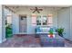 Inviting covered patio with string lights, comfortable seating, and quaint shutters for a relaxing outdoor experience at 880 N Shore Dr, Anna Maria, FL 34216