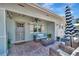 Cozy covered patio with brick flooring, comfortable seating, and stylish decor perfect for outdoor relaxation at 880 N Shore Dr, Anna Maria, FL 34216