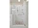 This all-white shower stall features subway tile, a pebble floor, and glass door enclosure at 880 N Shore Dr, Anna Maria, FL 34216