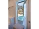The doorway reveals a backyard pool with clear blue water and a surrounding deck at 1004 65Th W Ave, Bradenton, FL 34207