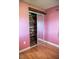 A pink bedroom featuring a mirrored sliding door closet at 1004 65Th W Ave, Bradenton, FL 34207