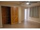 Bedroom with ceiling fan and closet with sliding barn door at 1004 65Th W Ave, Bradenton, FL 34207