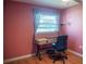 A cozy pink bedroom with a modern desk setup and ample natural light at 1004 65Th W Ave, Bradenton, FL 34207