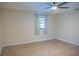 A spacious bedroom with hardwood floors, a ceiling fan, and a window providing natural light at 1004 65Th W Ave, Bradenton, FL 34207