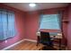 A bright bedroom featuring a desk area, window, and a modern ceiling fan at 1004 65Th W Ave, Bradenton, FL 34207