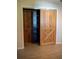 Bedroom closet with sliding barn door and built in shelves at 1004 65Th W Ave, Bradenton, FL 34207