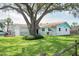 Well-kept front exterior with a beautiful mature tree and an inviting curb appeal at 1004 65Th W Ave, Bradenton, FL 34207