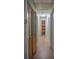 Hallway featuring wood floors and storage closets at 1004 65Th W Ave, Bradenton, FL 34207