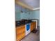 Kitchen with oak cabinets, dark countertops and stainless steel sink at 1004 65Th W Ave, Bradenton, FL 34207