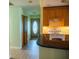 View of the kitchen with wood cabinets and white appliances looking toward the front door at 1004 65Th W Ave, Bradenton, FL 34207