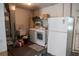 Functional laundry room with washer, dryer, sink, and a white refrigerator at 1004 65Th W Ave, Bradenton, FL 34207