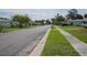 Wide residential street with well-kept lawns and single-Gathering homes at 1004 65Th W Ave, Bradenton, FL 34207