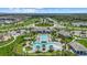 Aerial view of a community pool complex with multiple pools, sun loungers, and well-maintained landscaping at 10120 Canaveral Cir, Sarasota, FL 34241