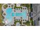 Aerial top-down view of a modern pool complex featuring distinct pools, lounge areas, and lush tropical landscaping at 10120 Canaveral Cir, Sarasota, FL 34241