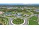 Extensive community with tennis courts and community pool featuring lush landscapes and circular boulevards at 10120 Canaveral Cir, Sarasota, FL 34241