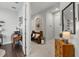 Inviting hallway featuring tile flooring, a decorative mirror, and seamless transitions to adjacent living spaces at 10120 Canaveral Cir, Sarasota, FL 34241