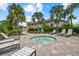 Outdoor hot tub with lounge chairs, landscaping, and well maintained grounds at 10120 Canaveral Cir, Sarasota, FL 34241