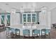Modern kitchen with large island, white cabinets, pendant lighting, and stainless steel appliances at 10120 Canaveral Cir, Sarasota, FL 34241