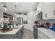 Modern kitchen featuring stainless steel appliances, white cabinets, gray island and tile backsplash at 10120 Canaveral Cir, Sarasota, FL 34241