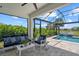 Outdoor lanai featuring comfortable seating and a beautiful pool view with waterfall feature at 10120 Canaveral Cir, Sarasota, FL 34241
