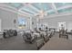 Comfortable lounge area with ample seating, ceiling detail and view of the outdoors at 10120 Canaveral Cir, Sarasota, FL 34241