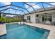 Screened-in pool with tanning ledge and a complete outdoor kitchen and dining area at 10120 Canaveral Cir, Sarasota, FL 34241