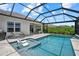 Screened in pool featuring in-pool seating and lounge chairs on the pool deck with a covered patio in the background at 10120 Canaveral Cir, Sarasota, FL 34241