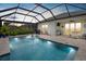 Screened-in pool with tanning ledge and a complete outdoor kitchen and dining area at 10120 Canaveral Cir, Sarasota, FL 34241