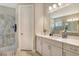 Bright bathroom features grey marble shower and white vanity with undermount sink at 10186 Crystal Isle Cir, Sarasota, FL 34241