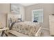 Comfortable bedroom with neutral tones and soft bedding and natural lighting at 10186 Crystal Isle Cir, Sarasota, FL 34241