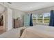 Bright bedroom featuring large windows with nature views, and light grey carpet at 10186 Crystal Isle Cir, Sarasota, FL 34241
