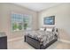 Bright bedroom featuring large windows with nature views, and dark furniture at 10186 Crystal Isle Cir, Sarasota, FL 34241