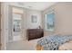 Cozy bedroom featuring a wooden dresser and view of the trees at 10186 Crystal Isle Cir, Sarasota, FL 34241
