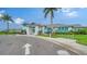 Stunning clubhouse with coastal architecture, lush landscaping, and convenient bicycle parking at 10186 Crystal Isle Cir, Sarasota, FL 34241