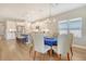 Open floor plan dining room featuring hardwood floors and modern chandelier next to a well-appointed kitchen at 10186 Crystal Isle Cir, Sarasota, FL 34241