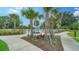 A landscaped walking path leads to a fenced dog park in a pet-friendly community at 10186 Crystal Isle Cir, Sarasota, FL 34241